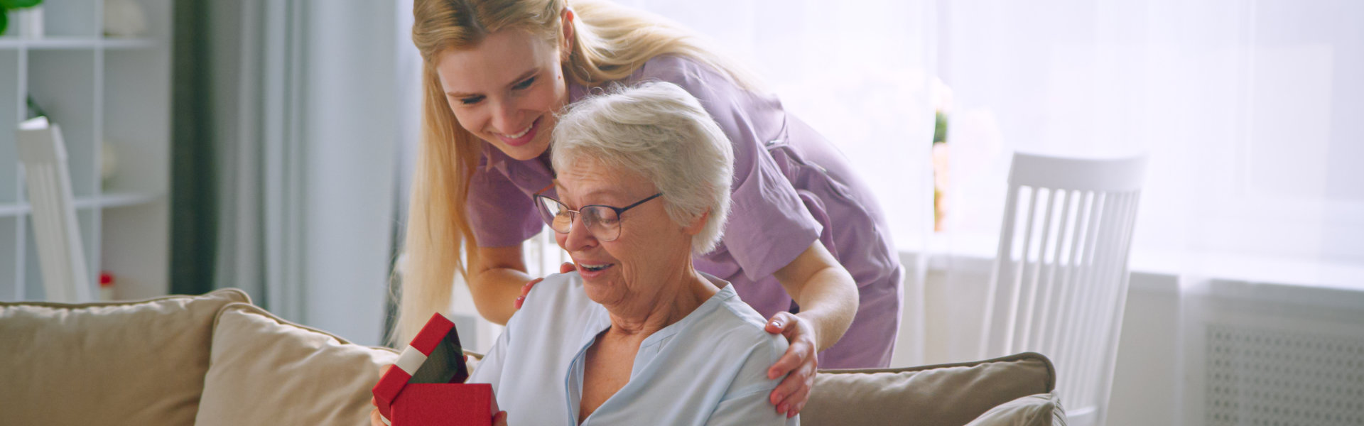 Woman Receives a Gift from a Young Adult Woman